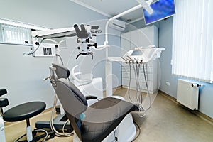 Modern dentistry office interior with chair and tools. Microscope in stomatology.