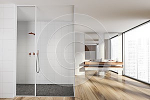 Modern design bathroom interior with glass shower cabin, double sink countertop, bronze faucets. Panoramic window with skyscrapers