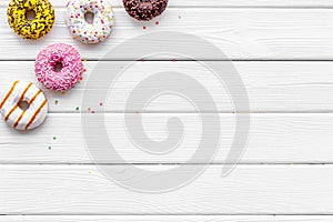 Modern design with bright donuts on white wooden background top view mock up