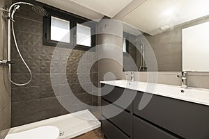 Modern designer bathroom with a walk-in shower without a screen, double white porcelain sinks and a frameless mirror on the wall