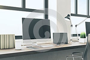 Modern designer desktop with empty black computer screen