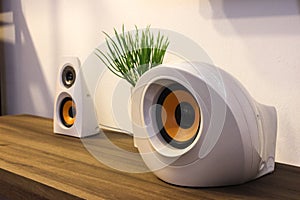 Modern designer speakers on wooden sideboard