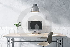 Modern designer wooden desktop with empty computer screen, lamp, decorative plant, chair and concrete wall background. Mock up, 3D
