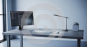 Modern desk setup with computer monitor displaying code and minimalist desk lamp