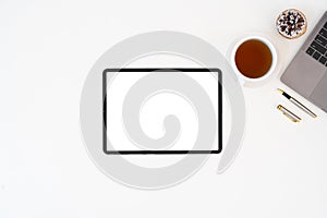 Modern desk workspace with blank copy space mockup with blank screen tablet, coffee cup, technology, headphones with
