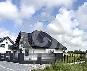 Modern detached house with graphite fence