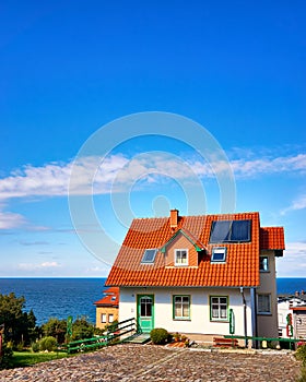 Modern detached house with red roof tiles and solar panels. Living overlooking the Baltic Sea on the island of RÃ¼gen