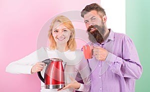 Modern devices make our life easier. Spending good morning together. Couple prepare morning drink electric kettle device