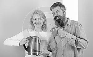 Modern devices make our life easier. Spending good morning together. Couple prepare morning drink electric kettle device