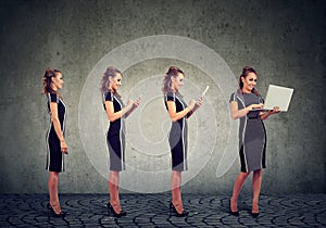 Modern digital devices and technology progress concept. Business woman using mobile phone, tablet and laptop computer