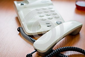 Modern digital phone, isolated on wooden background.The image of telephone. Voip Telephone Conference Call Office