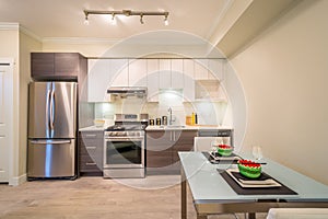Modern dining room table set for dinner with a kitchen in the background