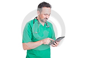 Modern doctor browsing internet with wireless tablet