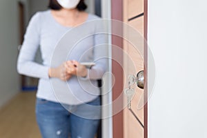 Modern doornkop and key with blurred woman inspector at new house,Door knob locks with keys