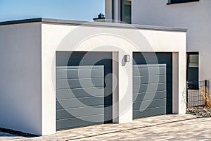 Modern double garage with sectional doors as a secure parking space in your own house
