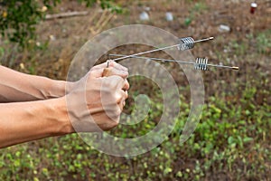 Modern dowsing with iron wire in hands. Search and study of geopathogenic and anomalous zones