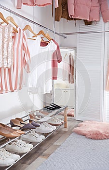 Modern dressing room with different stylish clothes