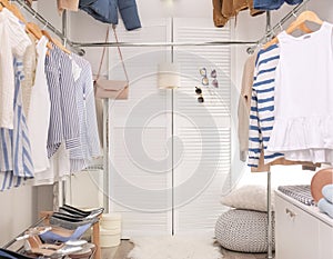 Modern dressing room with different stylish clothes