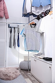 Modern dressing room with different stylish clothes