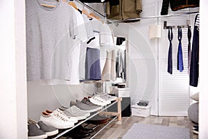 Modern dressing room with different stylish clothes