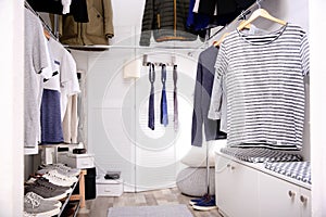 Modern dressing room with different stylish clothes