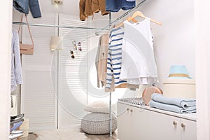 Modern dressing room with different stylish clothes