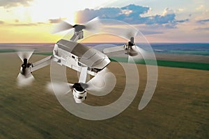 Modern drone flying over field at sunset. Aerial survey