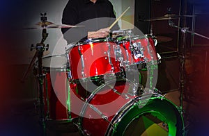 Modern drum set on stage prepared for playing in bright blue light