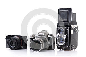Modern dslr camera, compact camera and vintage medium format two
