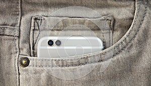Modern dual camera smart phone in jeans pocket