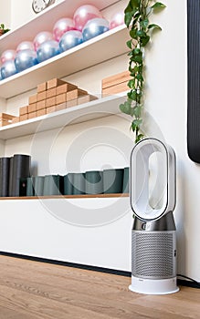 Modern Dyson fan heater in a gym interior