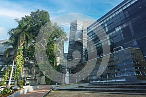 Modern eco-friendly glass architecture and greens against blue sky