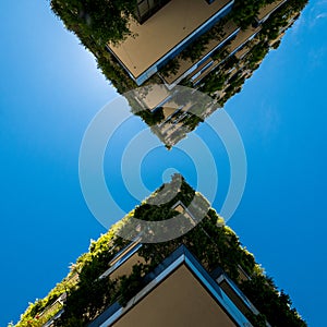 Modern and ecologic skyscrapers with many trees on every balcony