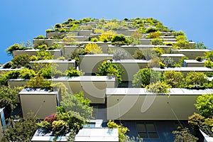 Modern and ecologic skyscrapers with many trees on every balcony