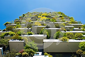 Modern and ecologic skyscrapers with many trees on every balcony