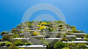 Modern and ecologic skyscrapers with many trees on every balcony