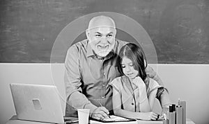 Modern education. Happy student. Student girl with teacher man at blackboard. Schoolgirl and tutor with laptop. Senior