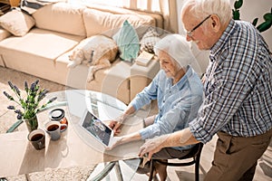 Modern Elderly Couple Using Digital Tablet