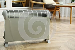 Modern electric convection heater on floor at home