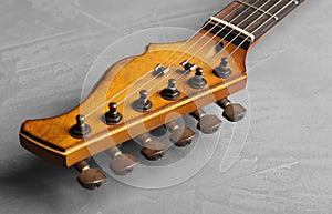 Modern electric guitar on color background