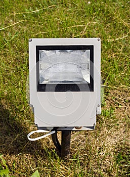 Modern electric lamp on city park field