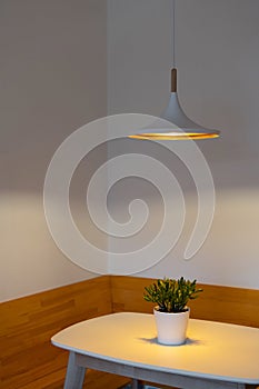 Modern electric lamp over white kitchen table