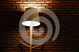 Modern electric lamp at the red brick wall