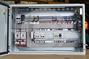 Modern electrical control Cabinet with controller and circuit breakers.