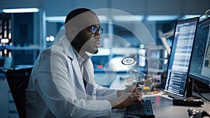 Modern Electronics Development Facility: Male Engineer Works on Computer with CAD Programming