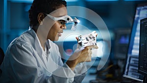 Modern Electronics Research, Development Facility: Black Female Engineer Wearing High-Tech Glasses