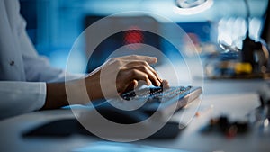 Modern Electronics Research, Development Facility: Engineer Working on Computer, Typing with His