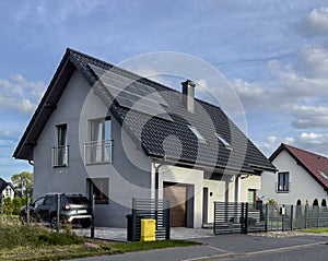 Modern elegant private house in Poland with solar panels and elegant metal fence