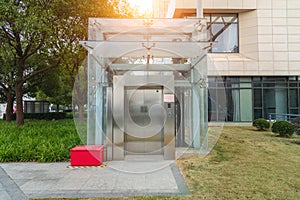 Modern elevator or lift with closed metal door in public park