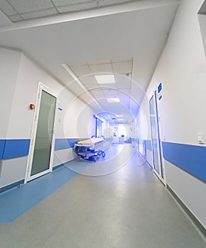 Modern empty hospital corridor with light walls. New long emergency clinic hall.